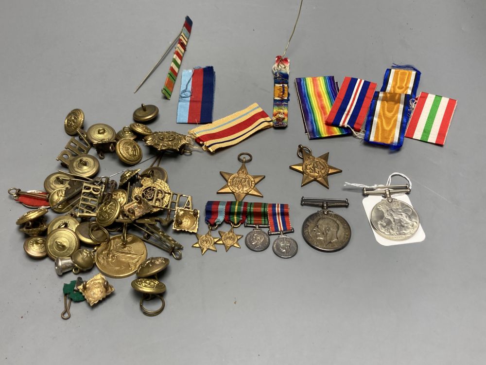 A WWII trio and a WWI pair, a collection of cap badges and non matching WWII miniatures